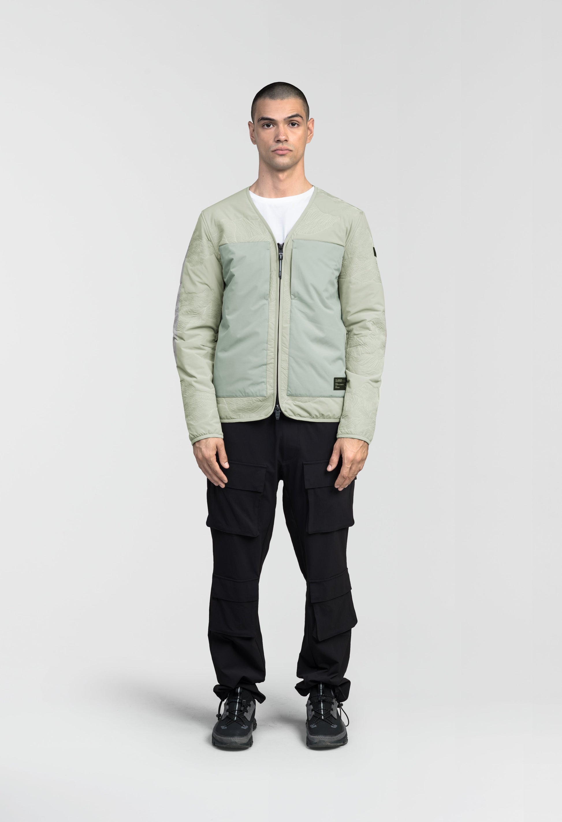 Gates Men's Performance Quilted V-Neck Jacket in hip length, centre front two-way zipper, hidden zipper chest pockets, side entry waist pockets, in Tea