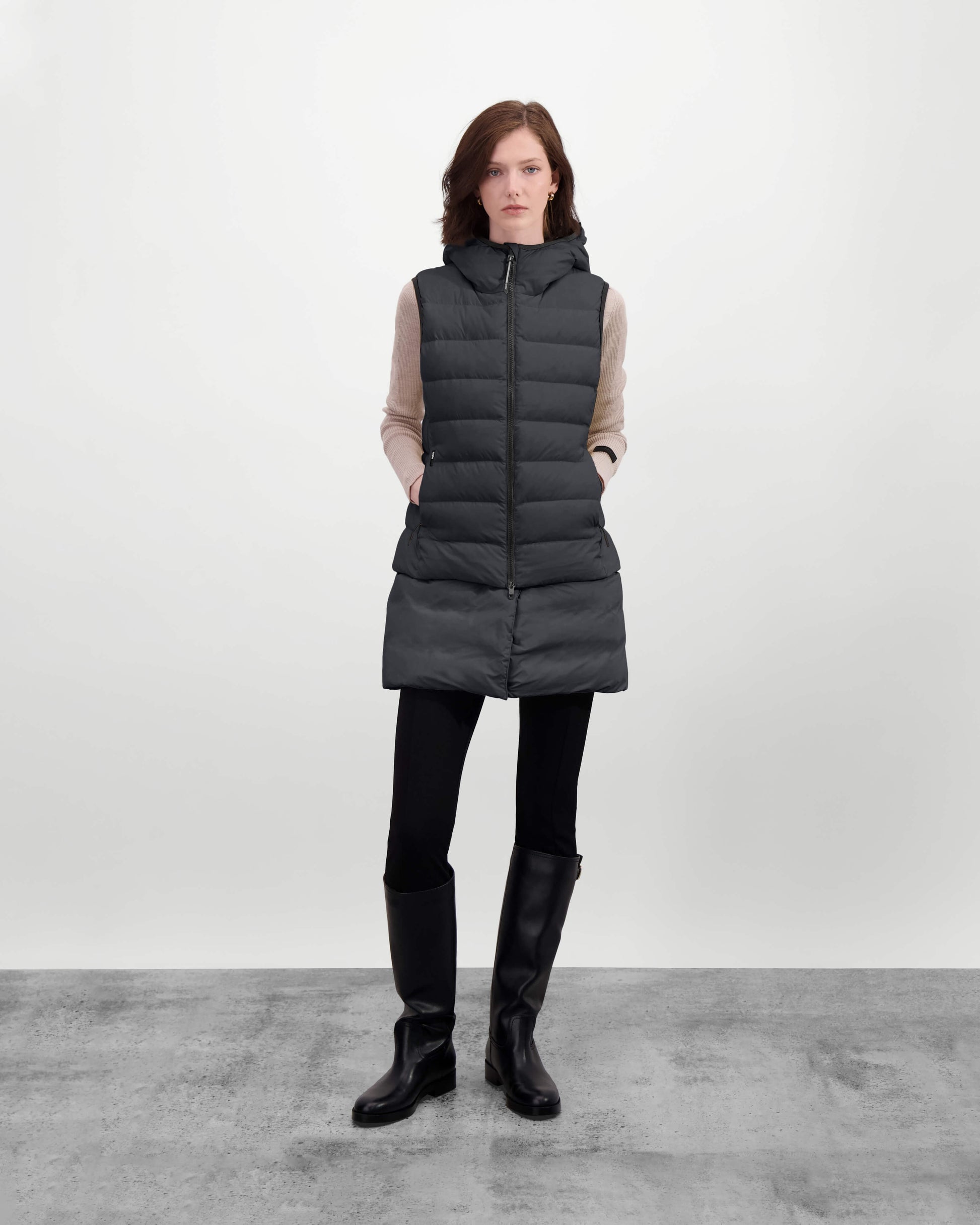 Saratoga puffer vest in Black insulated with Canadian white duck down, featuring stretch nylon ribbing for mobility, hidden waist drawcord, and a tailored fit for warmth and style. Lightweight and ideal for layering.