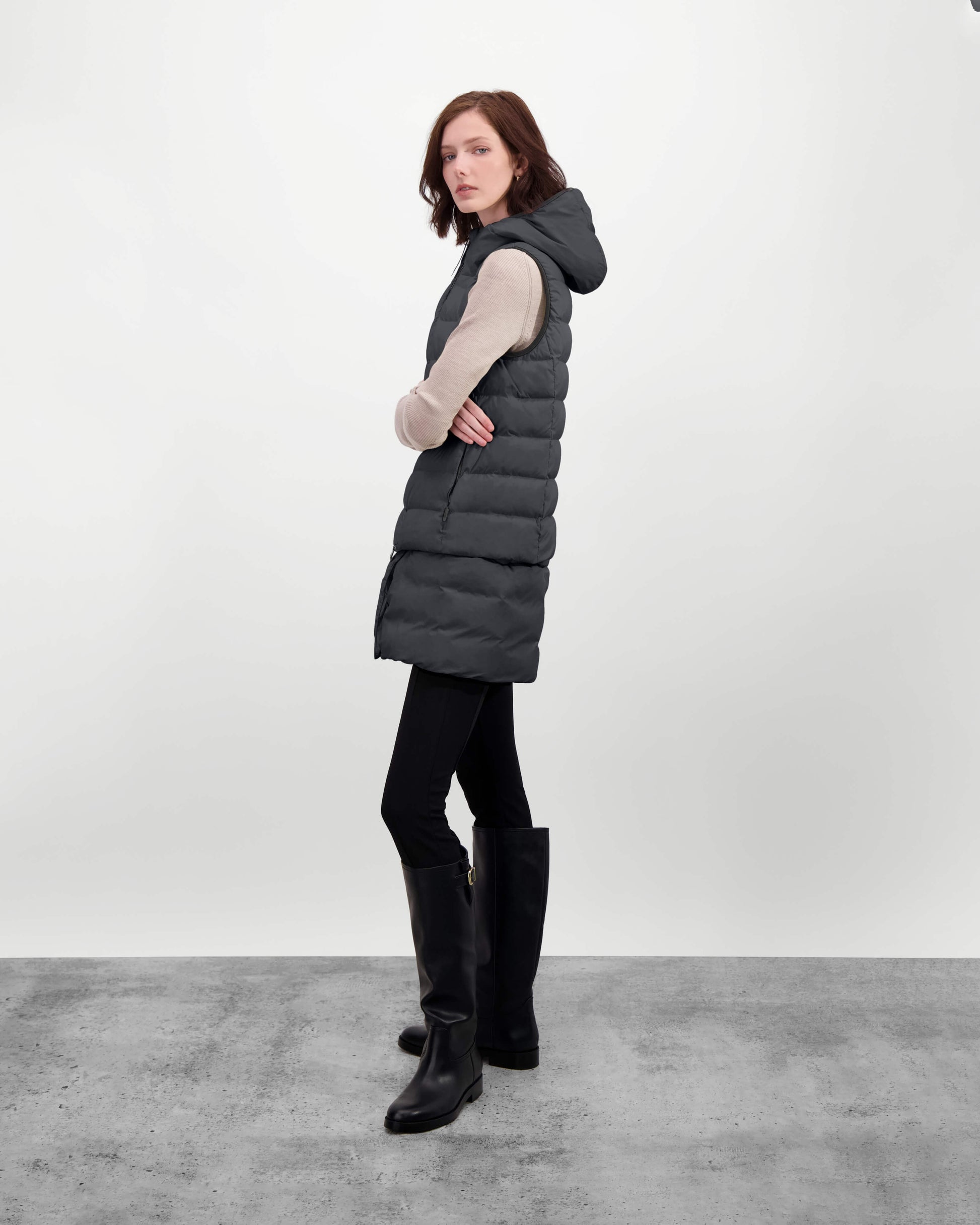 Saratoga puffer vest in Black insulated with Canadian white duck down, featuring stretch nylon ribbing for mobility, hidden waist drawcord, and a tailored fit for warmth and style. Lightweight and ideal for layering.