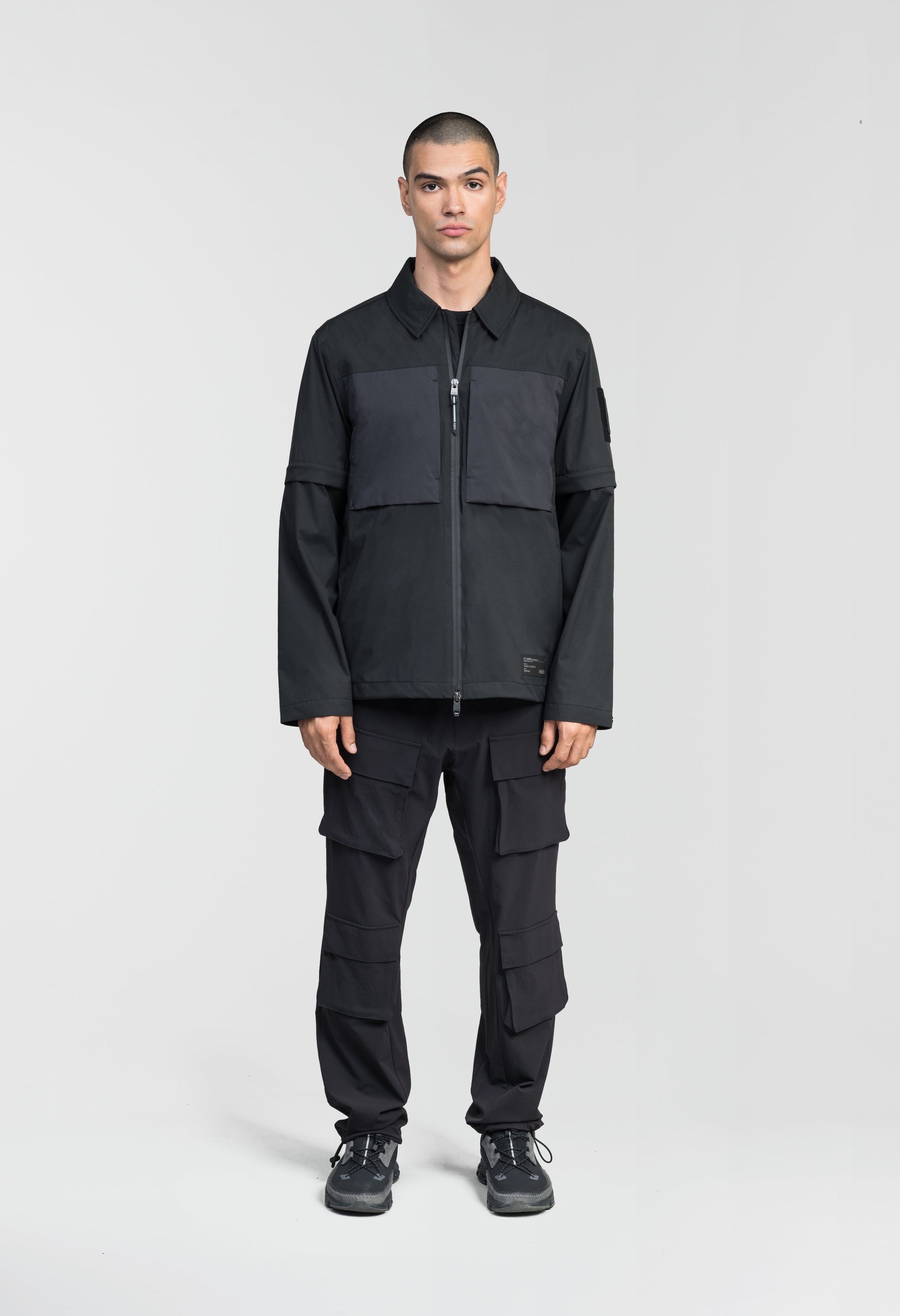 Thurlow Men's Performance Zip Off Sleeve Rain Shirt in hip length, convertible collar, patch chest zipper pockets, hidden in-seam pockets, zip off sleeves, centre front two-way zipper closure, in Black