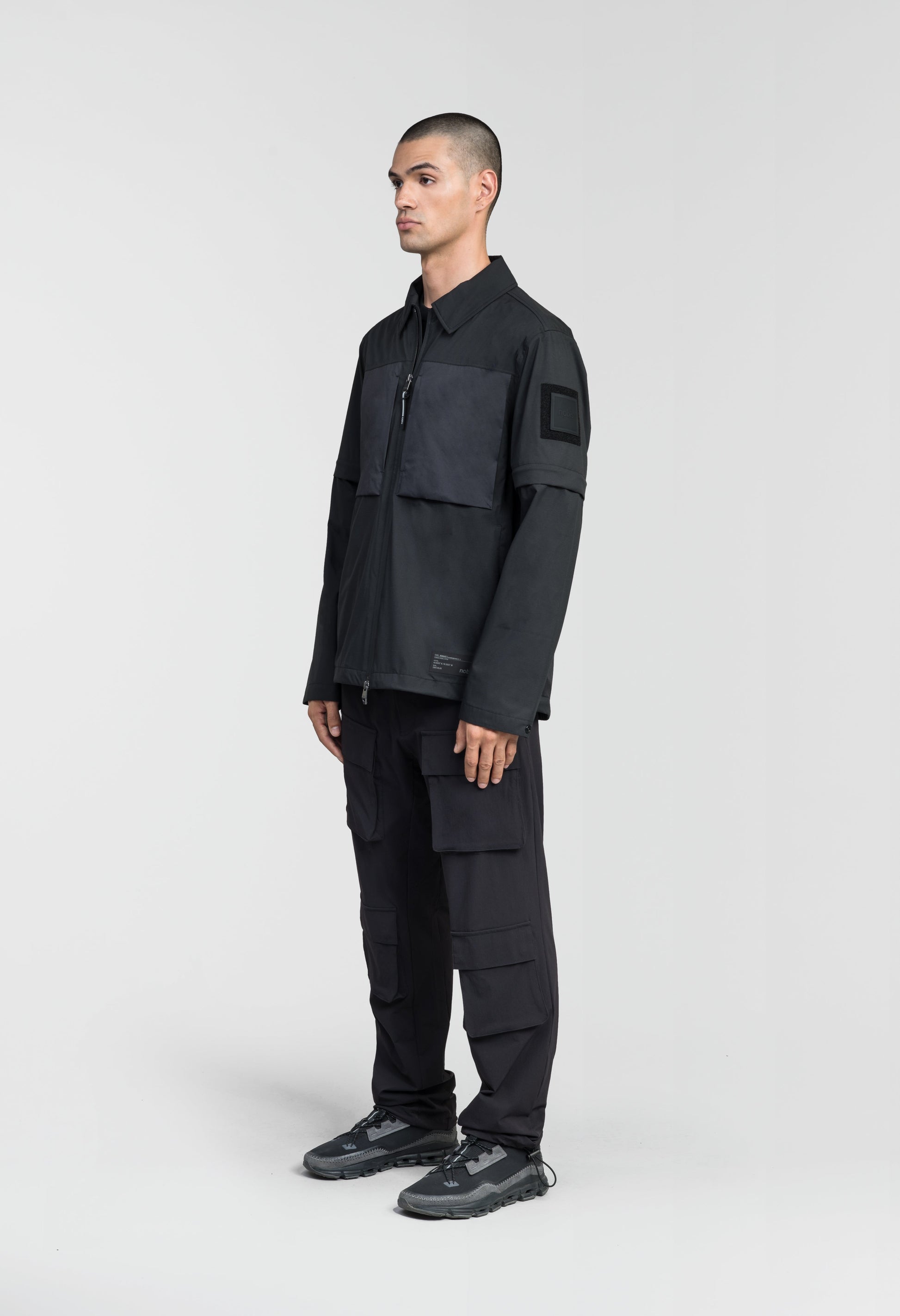 Thurlow Men's Performance Zip Off Sleeve Rain Shirt in hip length, convertible collar, patch chest zipper pockets, hidden in-seam pockets, zip off sleeves, centre front two-way zipper closure, in Black