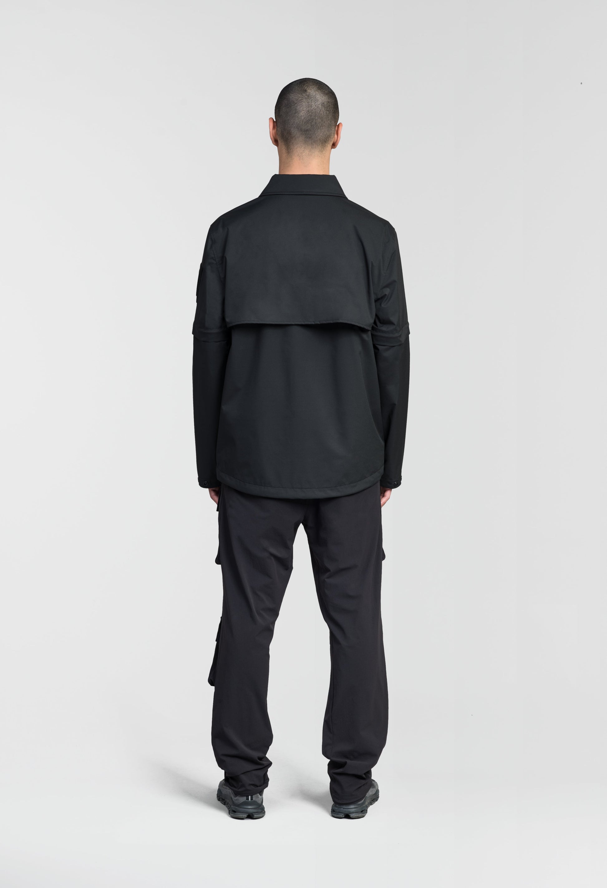 Thurlow Men's Performance Zip Off Sleeve Rain Shirt in hip length, convertible collar, patch chest zipper pockets, hidden in-seam pockets, zip off sleeves, centre front two-way zipper closure, in Black