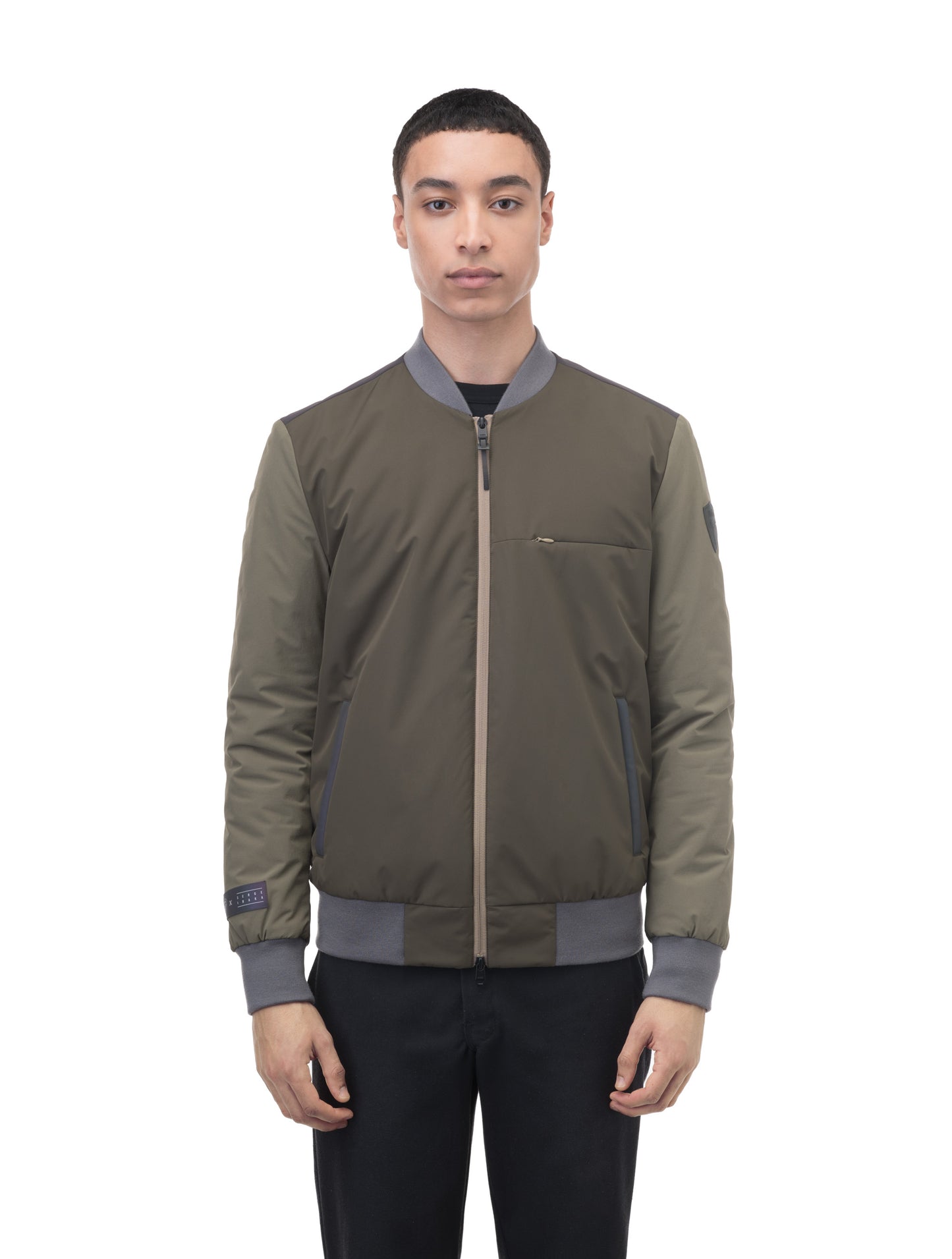 Unisex hip length bomber jacket with a contrast colour back panel, and zipper pockets at waist and an invisible zipper pocket at chest, in Dusty Olive/Licorice