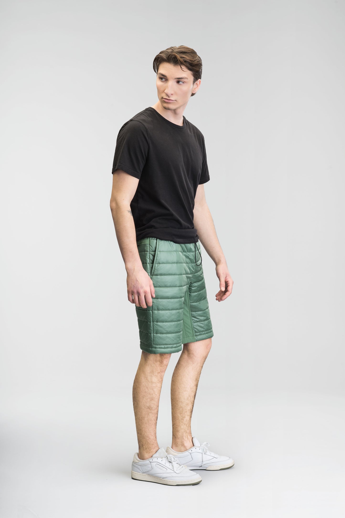 Decker Men's Performance Quilted Shorts in knee length, premium cire technical nylon taffeta and stretch nylon fabrication, premium 4-way stretch, water-resistant Primaloft Gold Insulation Active+, side seam pockets, invisible zipper back pokcet, elasticized waist with drawcords, and hidden drawcord at leg hems, in Comfrey