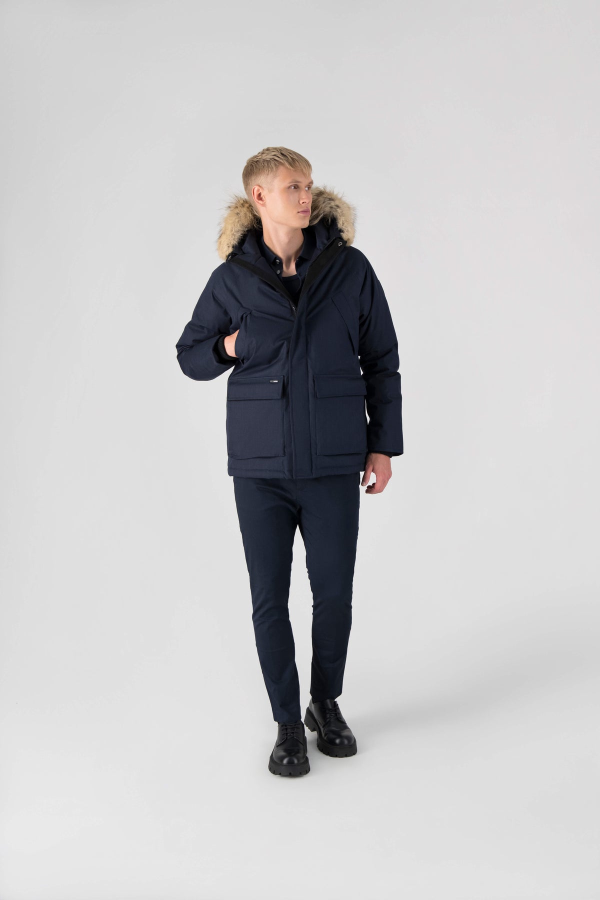 Men's waist length down filled jacket with two front pockets with magnetic closure and a removable fur trim on the hood in Navy