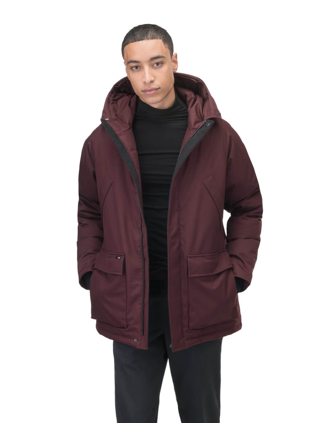 Men's waist length down filled jacket with two front pockets with magnetic closure and a removable fur trim on the hood in Merlot