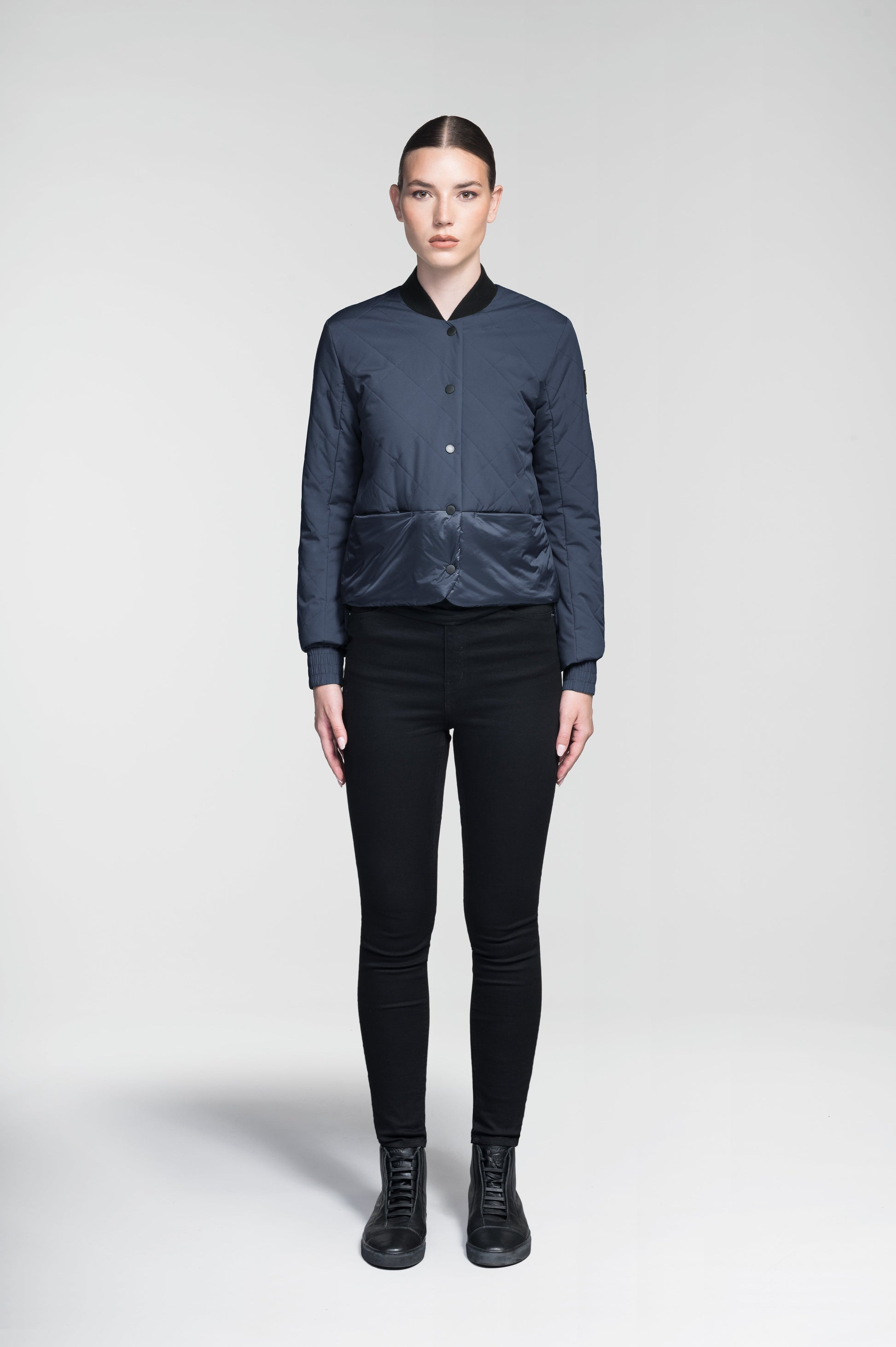 Lexi Women's Reversible Midlayer Jacket in waist length, premium stretch ripstop and contrast cire technical nylon taffeta fabrication, premium 4-way stretch, water resistant Primaloft Gold Insulation Active+, snap button closure at centre front, exterior magnetic closure pockets at sides, elasticized cuff details, and reversible from a quilted or smooth outer shell, in Marine