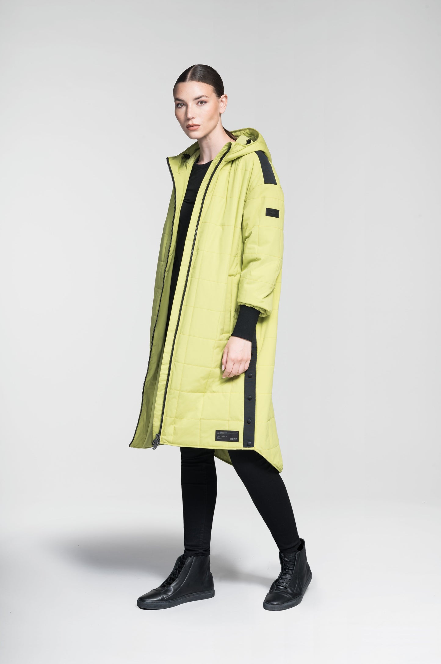 Radar Women's Performance Long Midlayer Jacket in long length, premium stretch ripstop and stretch Toray nylon fabrication, premium 4-way stretch, water resistant Primaloft Gold Insulation Active+, non-removable hood with adjustable draw cord, 2-way branded zipper at centre front, single welt pockets with magnetic closure at hips, elongated ribbed cuffs, grosgrain ribbon detail at shoulder and side seams, and snap closure side seam vent, in Dark Citron