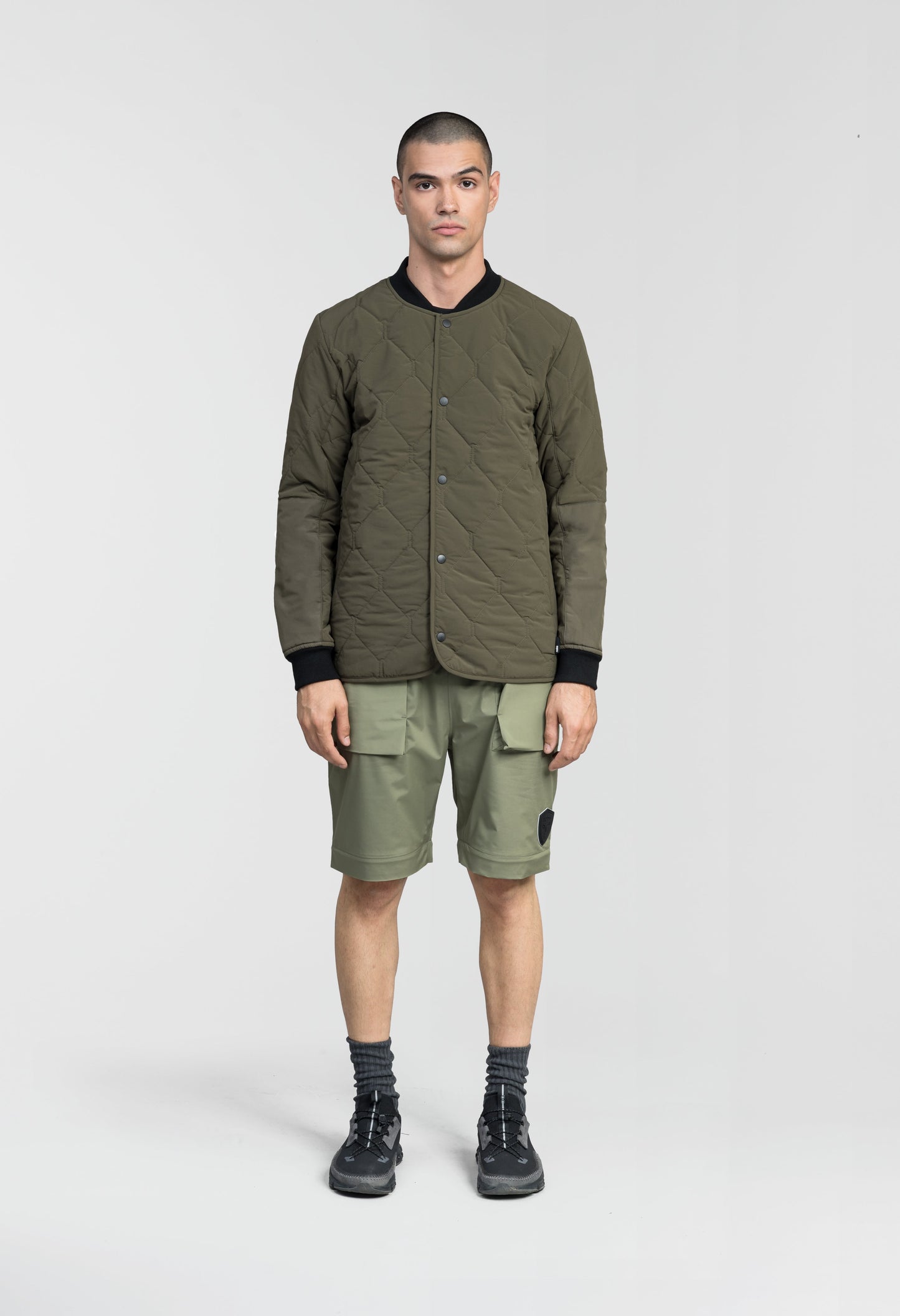 Speck Men's Tailored Mid Layer Jacket in hip length, Primaloft Gold Insulation Active+, diamond quilted body, rib knit collar and cuffs, snap buton front closure, and hidden side-entry zipper pockets at waist, in Fatigue