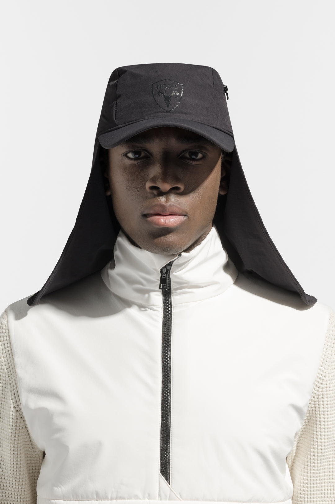 Tal Unisex 3-in-1 cap in 5-panel construction, curved peak brim, back flap, adjustable cobra buckle at back, zipper pocket on left side crown, and detachable face covering, in Black