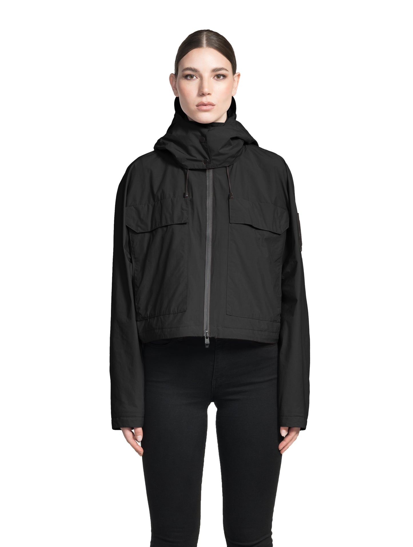Viva Women's Performance Cropped Jacket in waist length, premium iridescent fabrication, removable hood with peak, adjustable hood draw cords and toggle, 2-way branded zipper at centre front, oversized magnetic closure flap pockets at chest with side entry, interior adjustable draw cord at hem, large interior zipper pocket, and adjustable snap cuffs, in Black