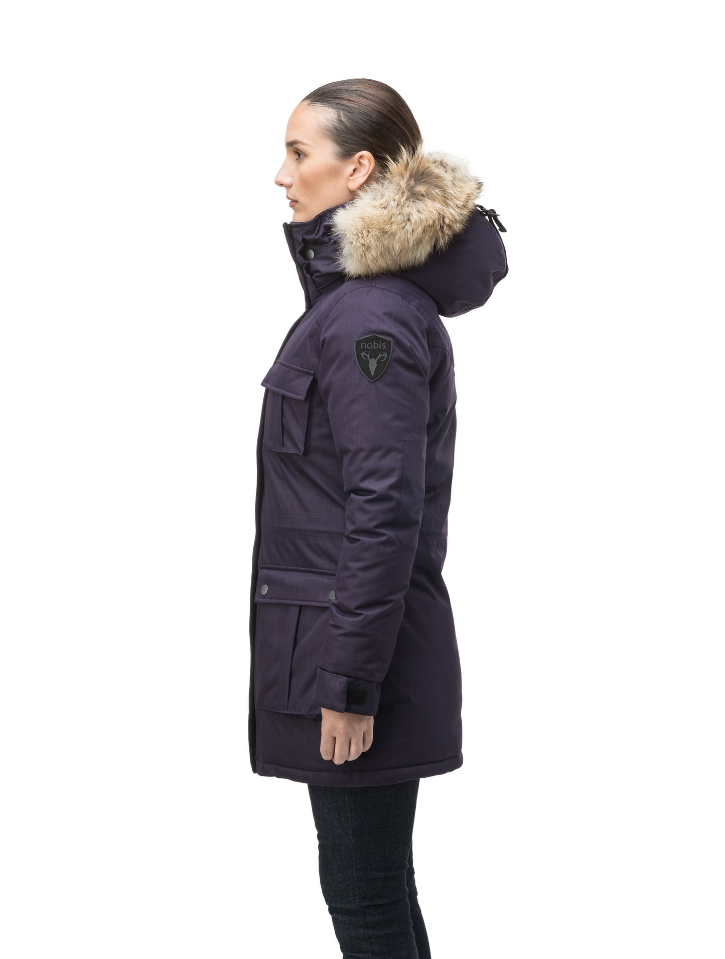 Women's down filled thigh length parka with four pleated patch pockets and an adjustable waist in CH Purple