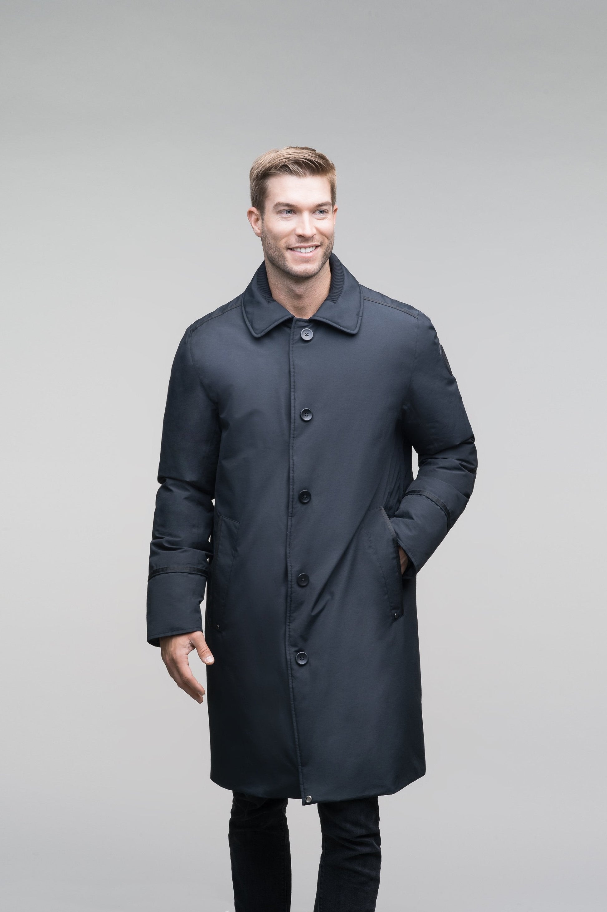 Men's long down filled overcoat with faux fur trim in Cy Black