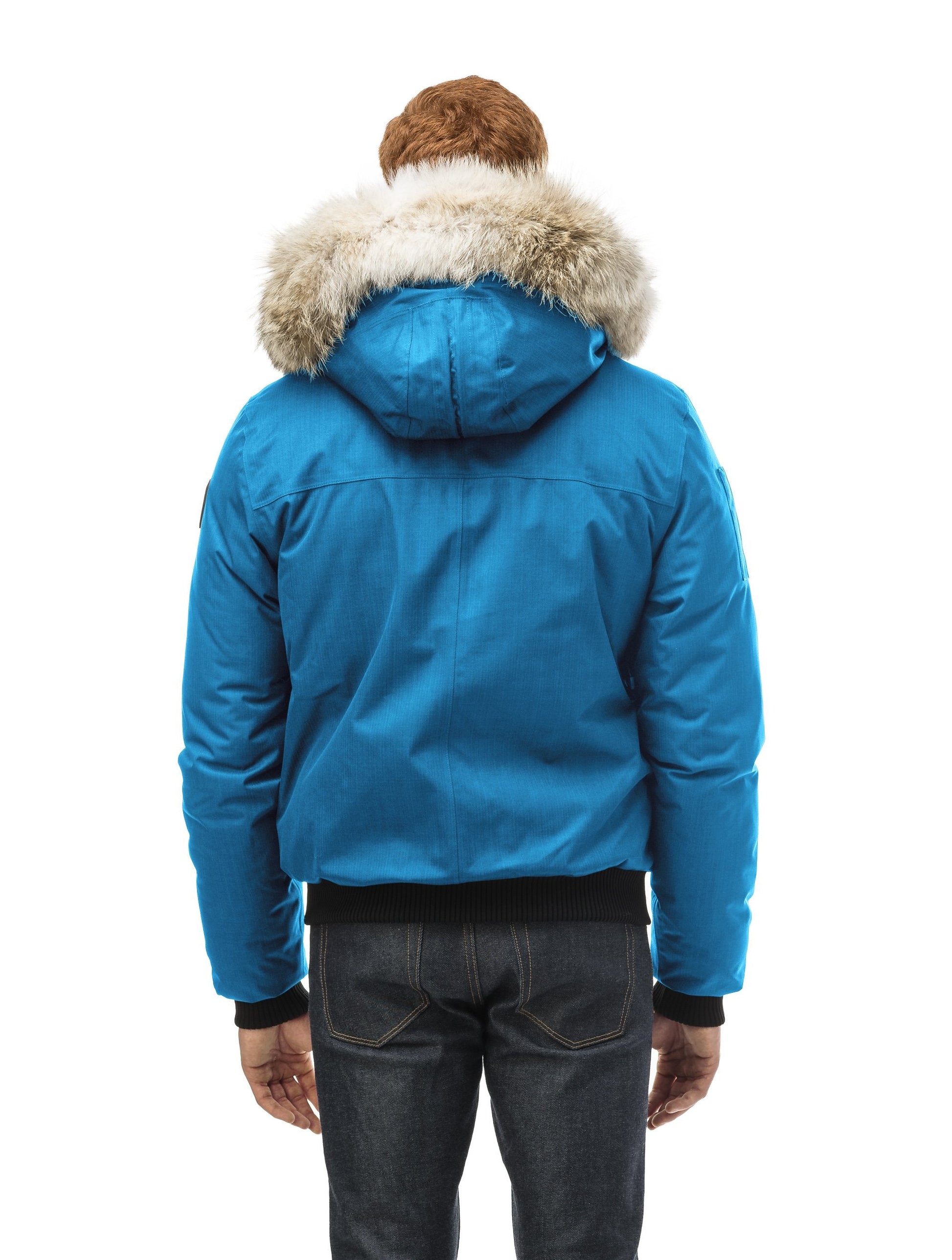 Men's classic down filled bomber jacket with a down filled hood that features a removable coyote fur trim and concealed moldable framing wire in Sea Blue