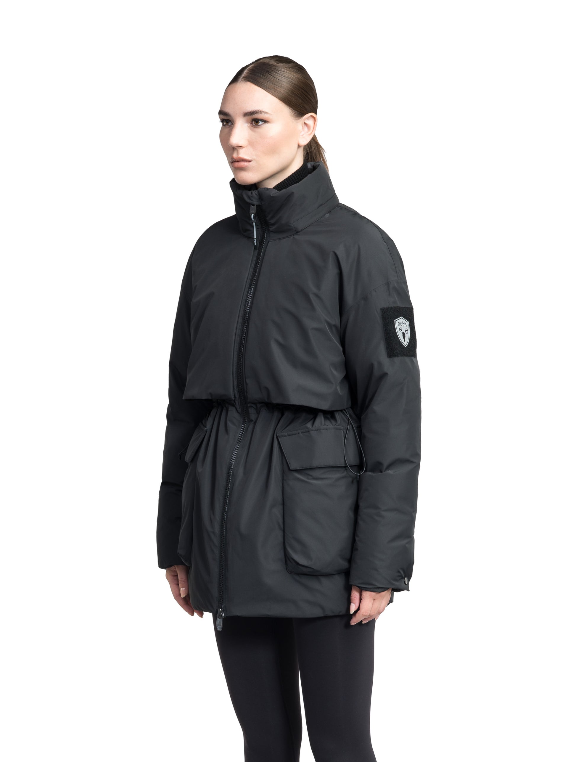 Haelyn Ladies Short Utility Parka in thigh length, 3-Ply Micro Denier fabrication, Premium Canadian White Duck Down insulation, removable down-filled hood, two-way centre front zipper, hidden adjustable cord at waist, adjustable snap cuffs, and four exterior patch pockets at front, in Black