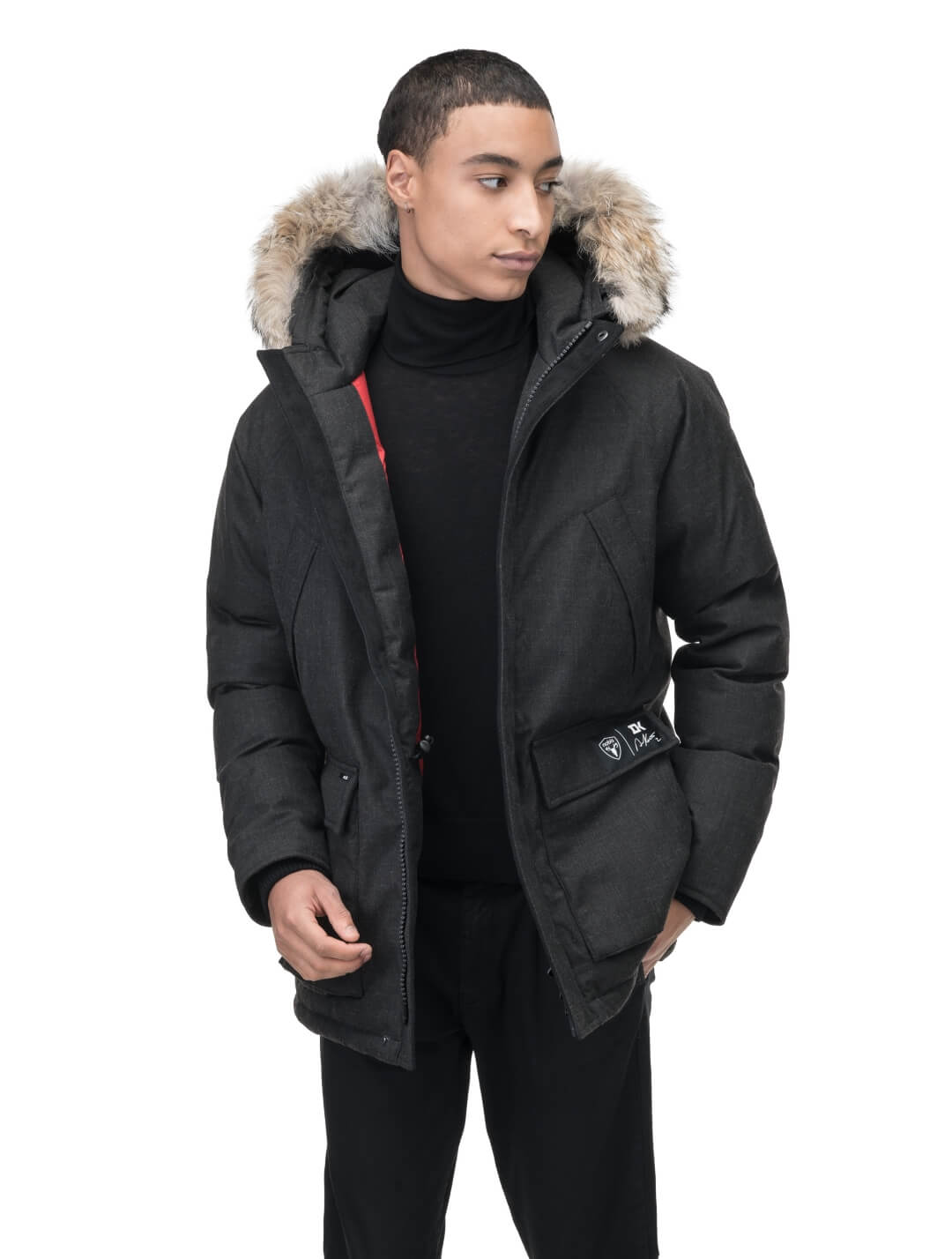 Duncan Keith Heritage Men's Parka in hip length, and features Canadian duck down insulation, non-removable hood with removable coyote fur trim, fleece-lined chest pockets, top and side entry waist pockets, adjustable waist cord, interior zipper pocket, and co-branding with Keith's signature on the left outer waist pocket, in H. Black