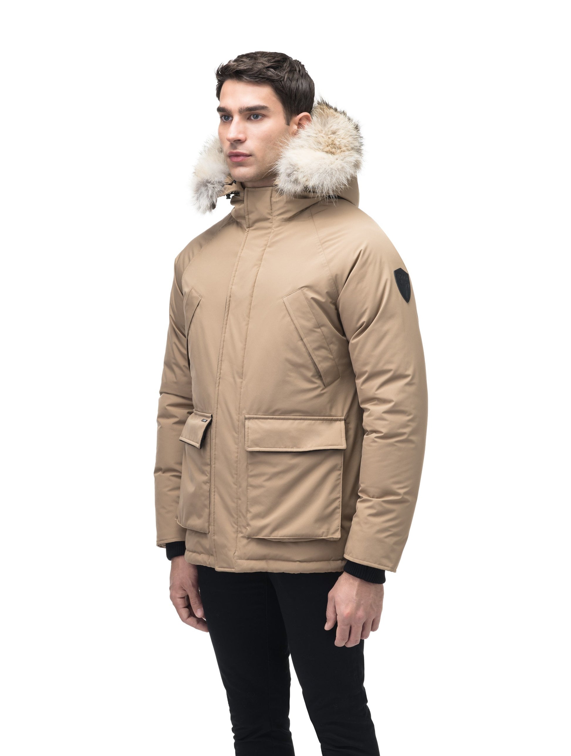 Men's waist length down filled jacket with two front pockets with magnetic closure and a removable fur trim on the hood in Cork