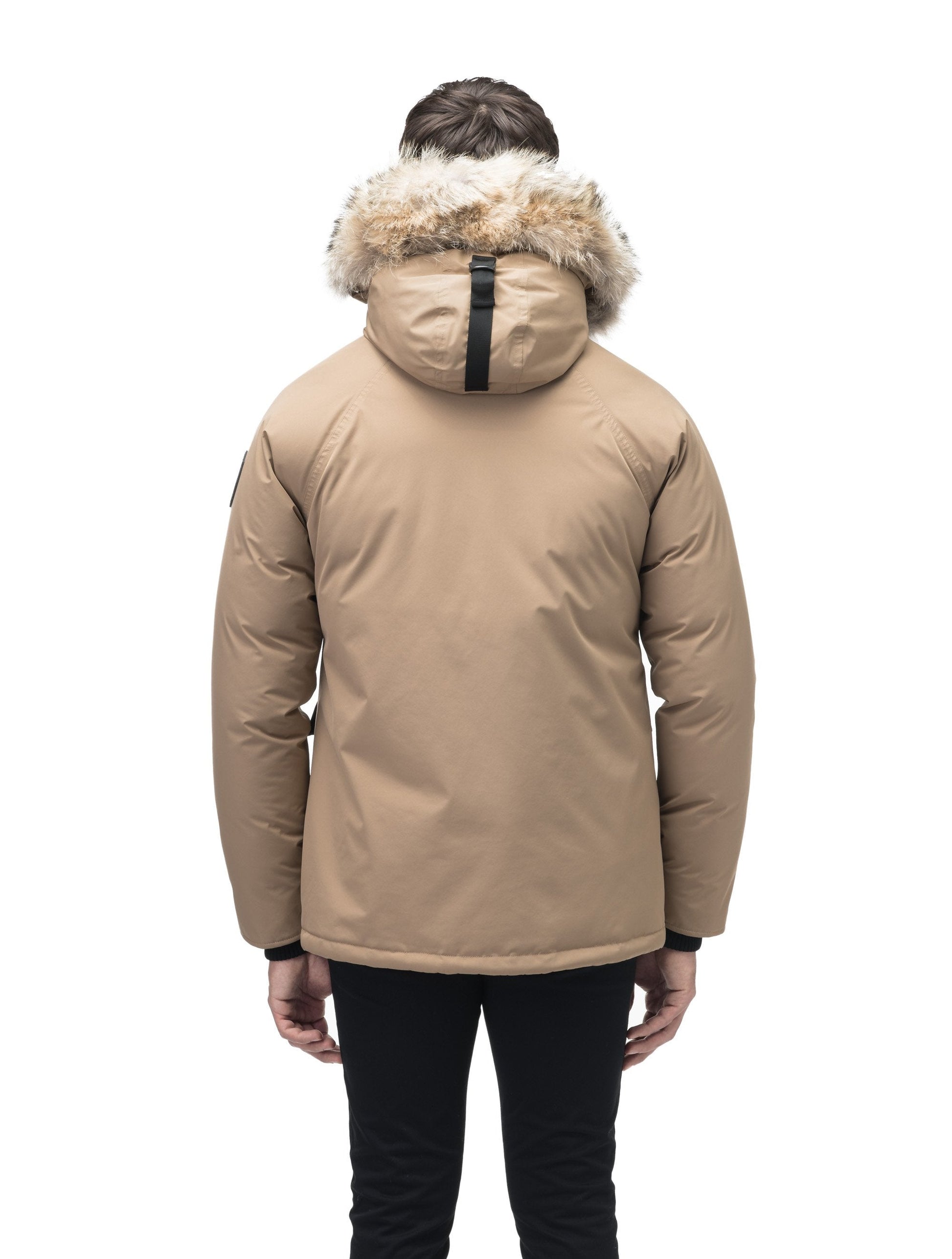 Men's waist length down filled jacket with two front pockets with magnetic closure and a removable fur trim on the hood in Cork