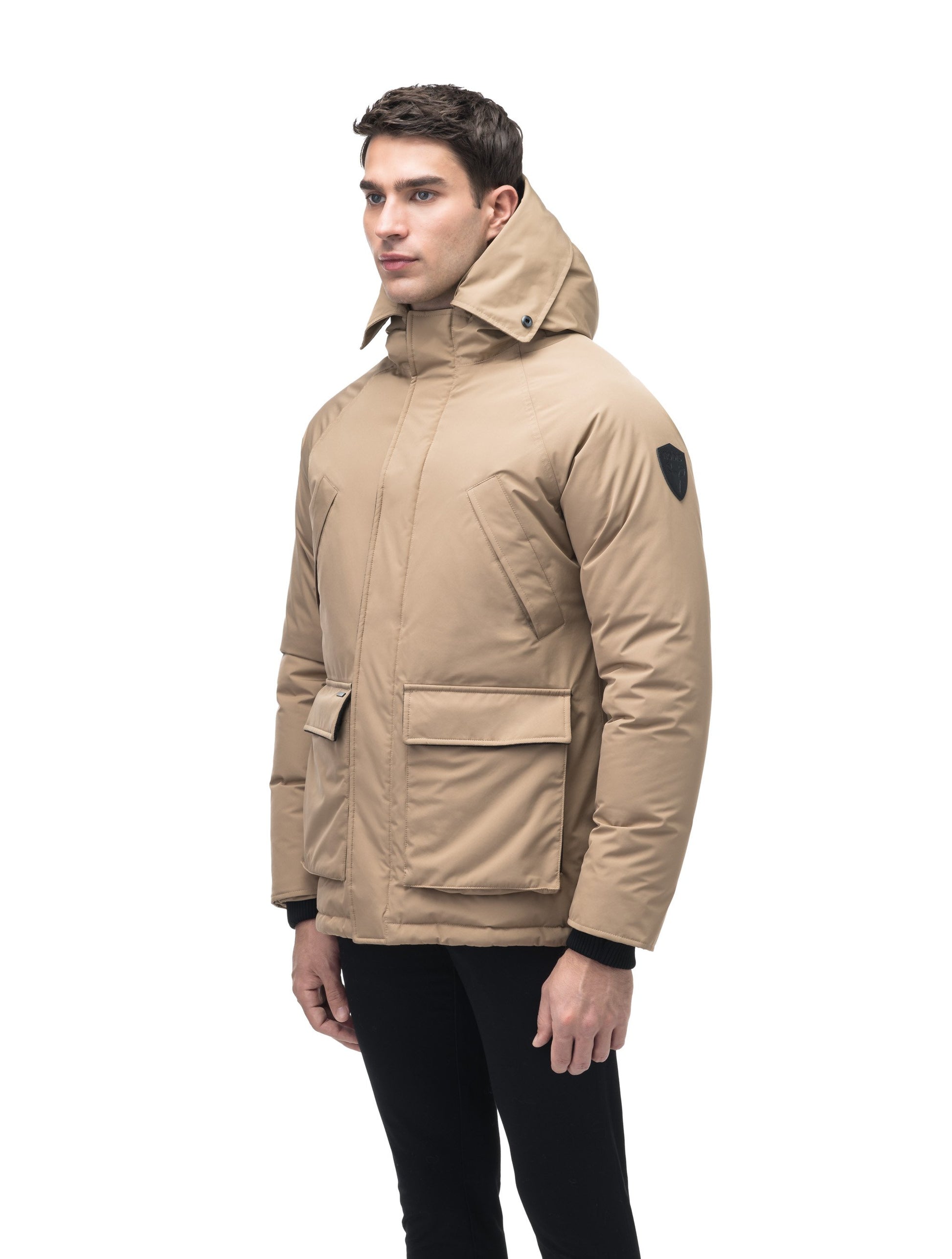 Men's waist length down filled jacket with two front pockets with magnetic closure and a removable fur trim on the hood in Cork