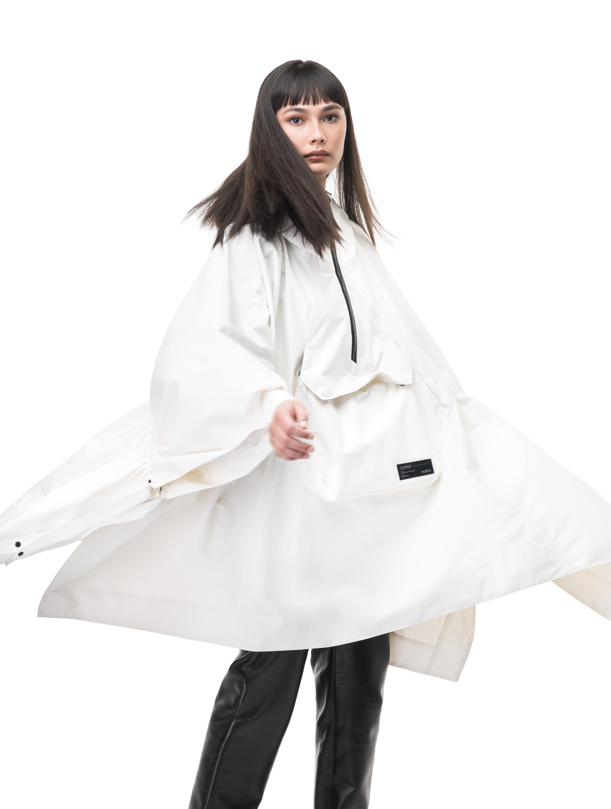 Hydra Unisex Performance Poncho in thigh length, non-removable hood, vertical half-zipper along centre front collar, hidden side-entry waist zipper pockets, adjustable webbing straps and snap closure cuffs, and packable to front kangaroo pocket with flap opening, in Chalk