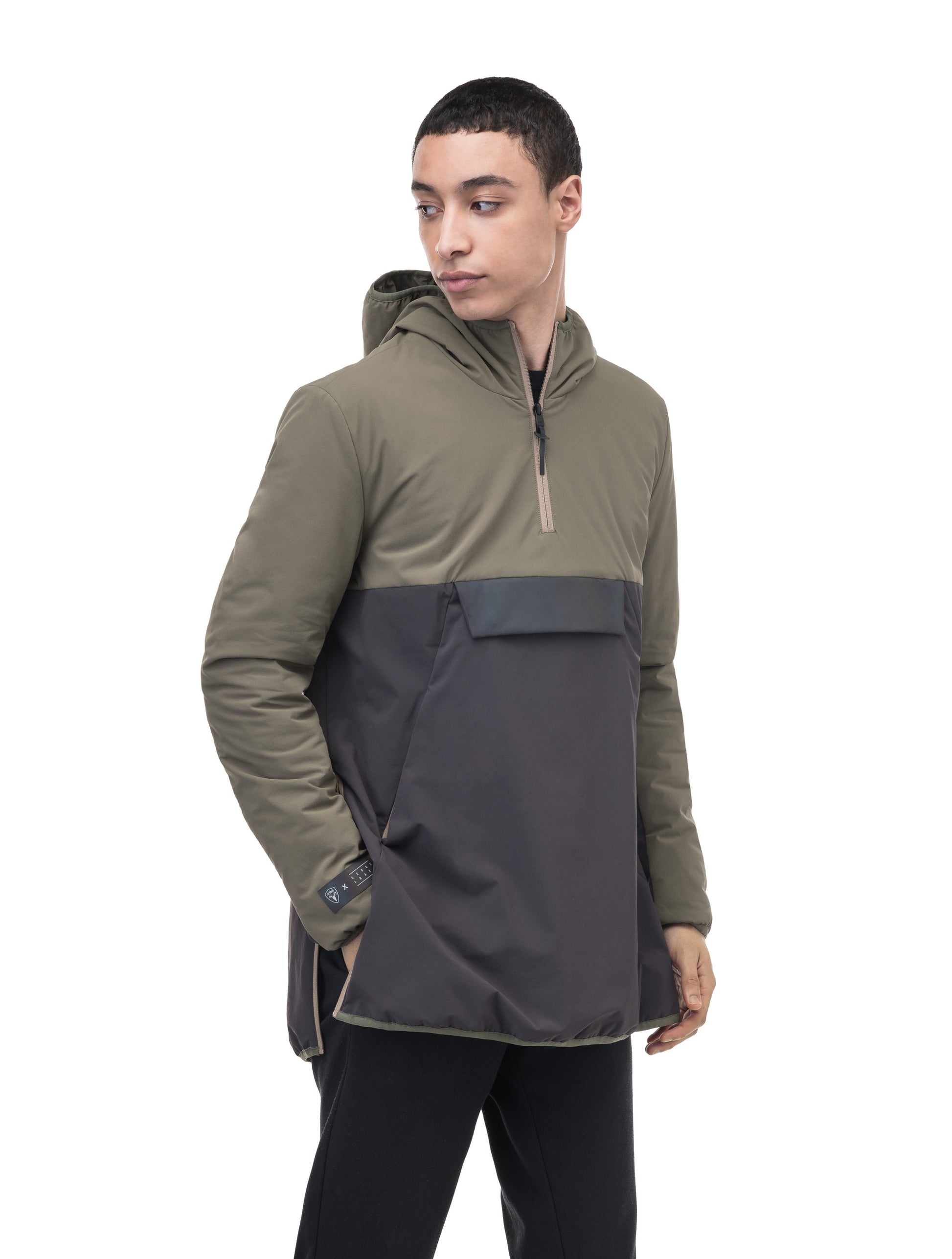Unisex thigh length hooded anorak with vertical zipper along collar, side zippers along torso, and centre zipper pouch with a reflective flap, in Dusty Olive/Licorice