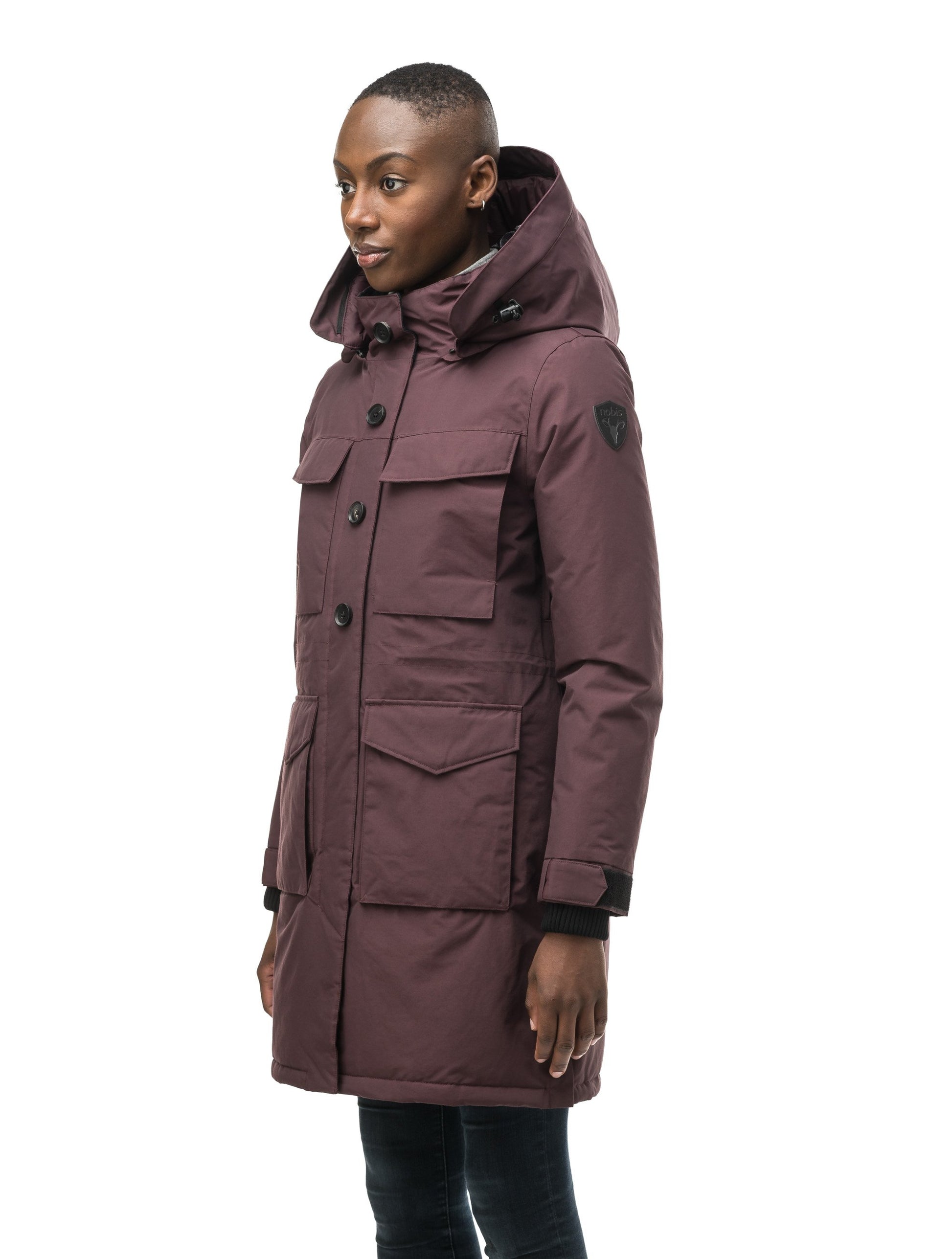 Women's knee length down filled parka with two chest patch pockets and two waist patch pockets in Burgundy