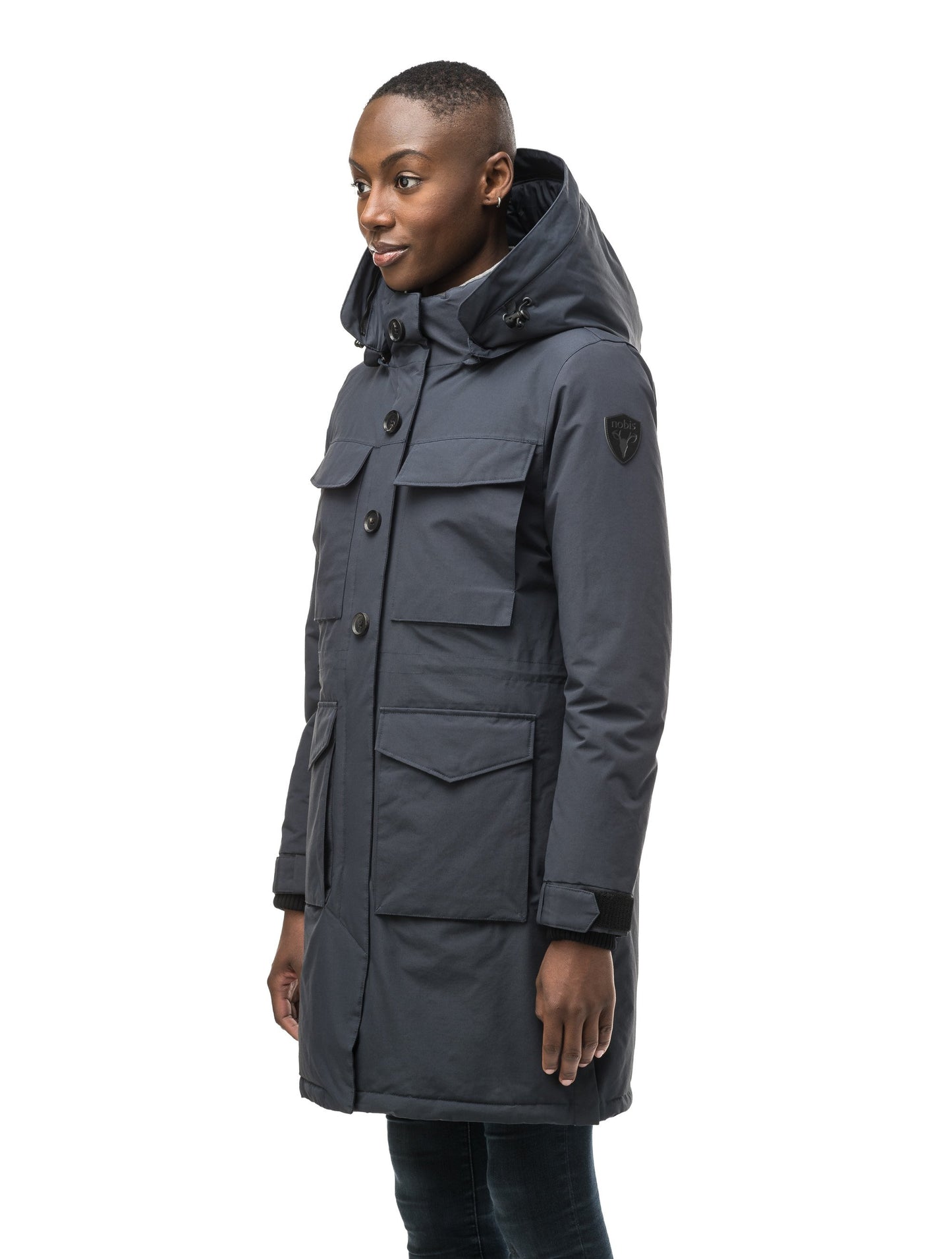 Women's knee length down filled parka with two chest patch pockets and two waist patch pockets in Navy