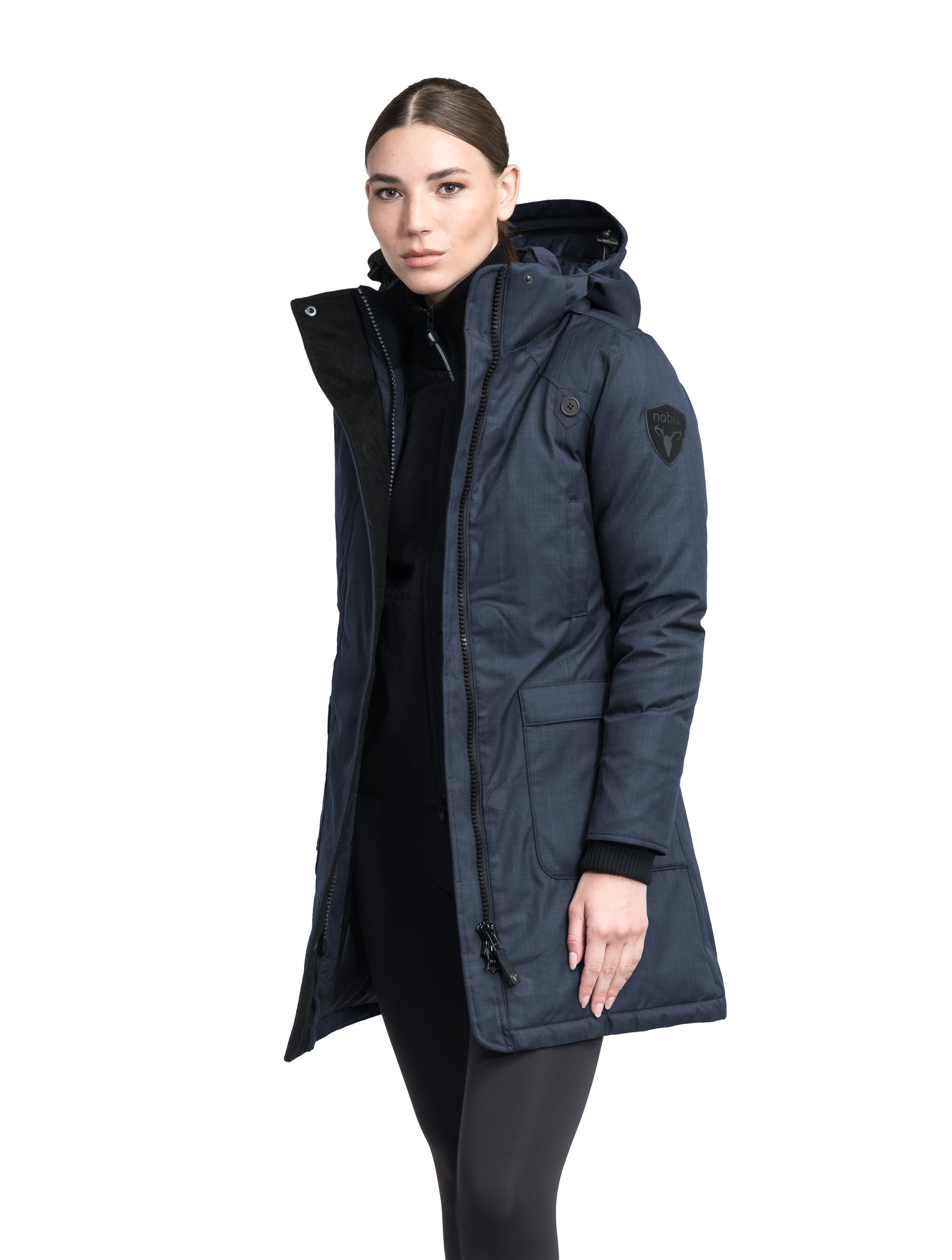 Merideth Furless Ladies Parka in thigh length, Canadian white duck down insulation, removable down-filled hood, centre-front two-way zipper with magnetic wind flap closure, four exterior pockets, and elastic ribbed cuffs, in Navy