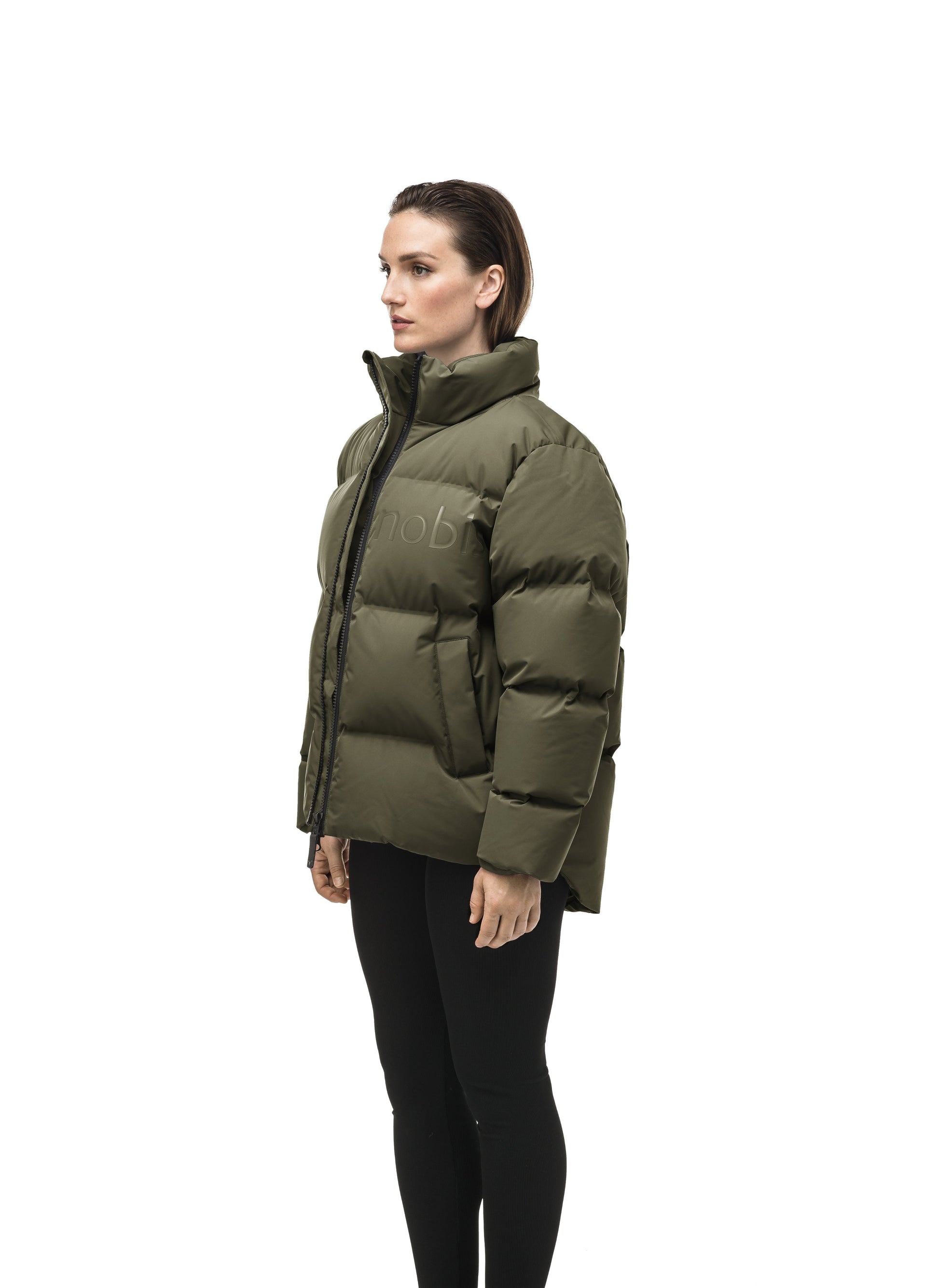 Women's puffer jacket with a minimalist modern design; featuring graphic details like oversized tonal branding, an exposed zipper, and seamless puffer channels to lock in the Premium Canadian Origin White Duck Down in Fatigue