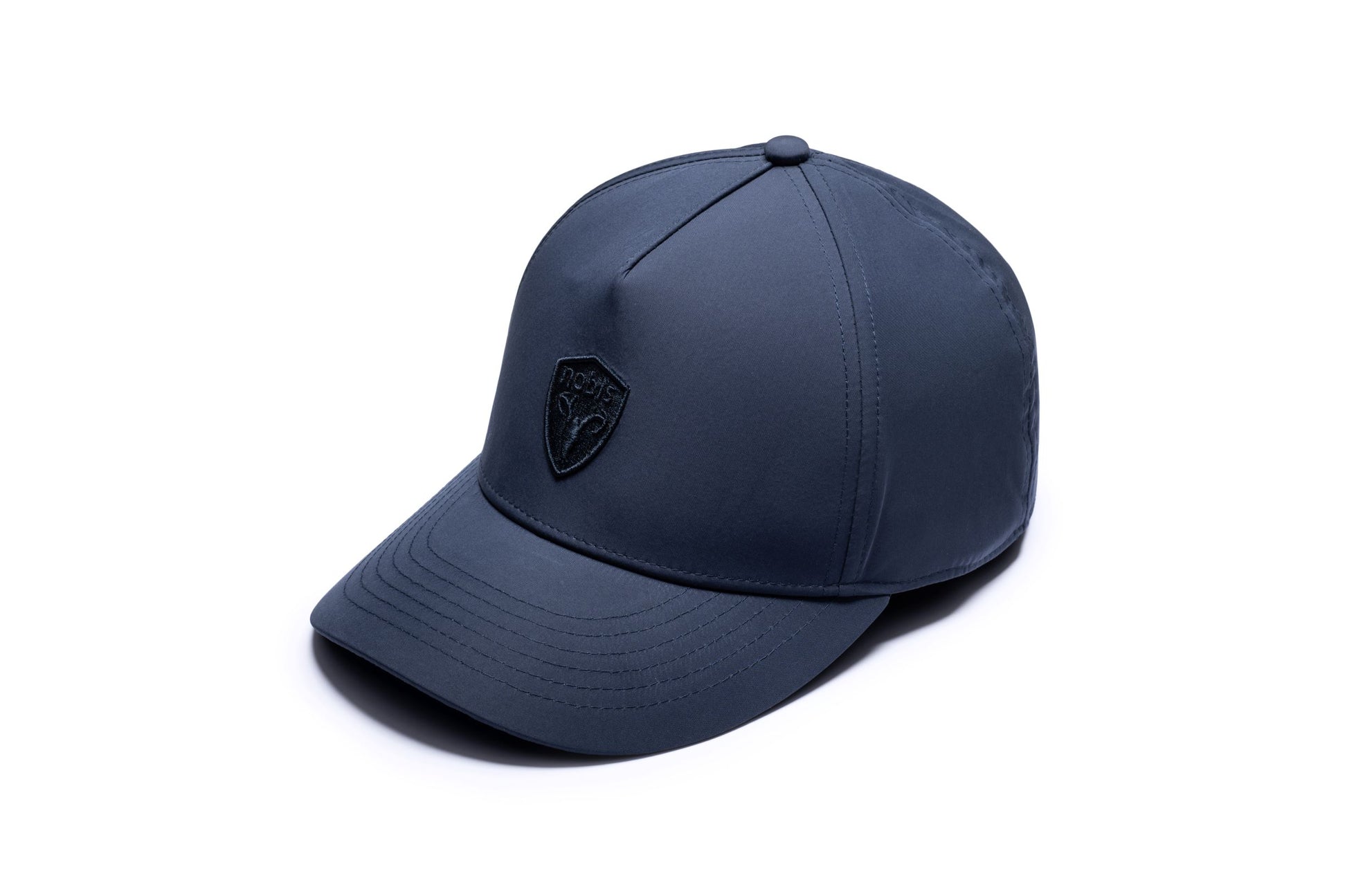Satine Adjustable Cap in 5-panel construction, mid height crown, curved peak brim, and adjustable strap closure, in Marine