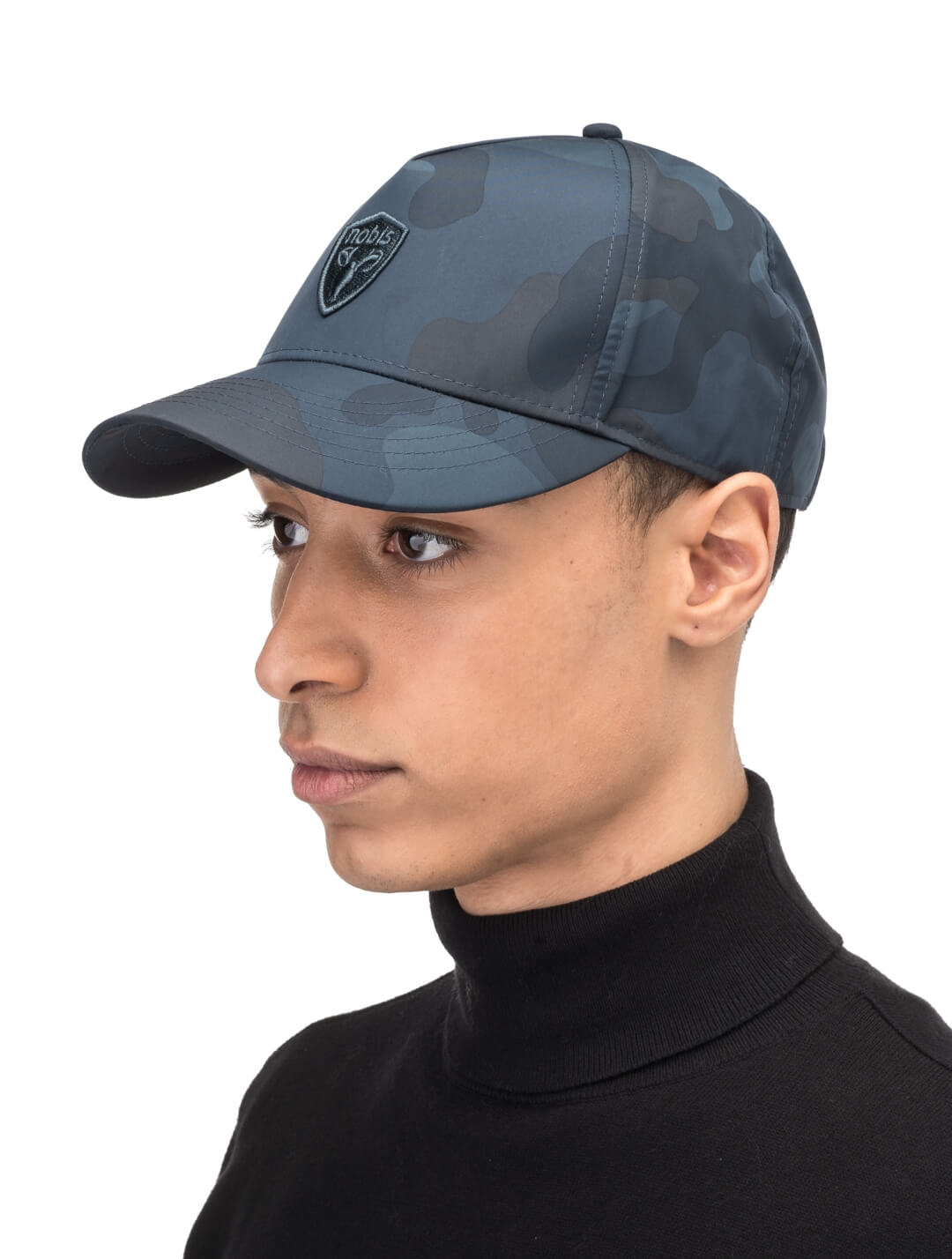 Satine Adjustable Cap in 5-panel construction, mid height crown, curved peak brim, and adjustable strap closure, in Navy Camo