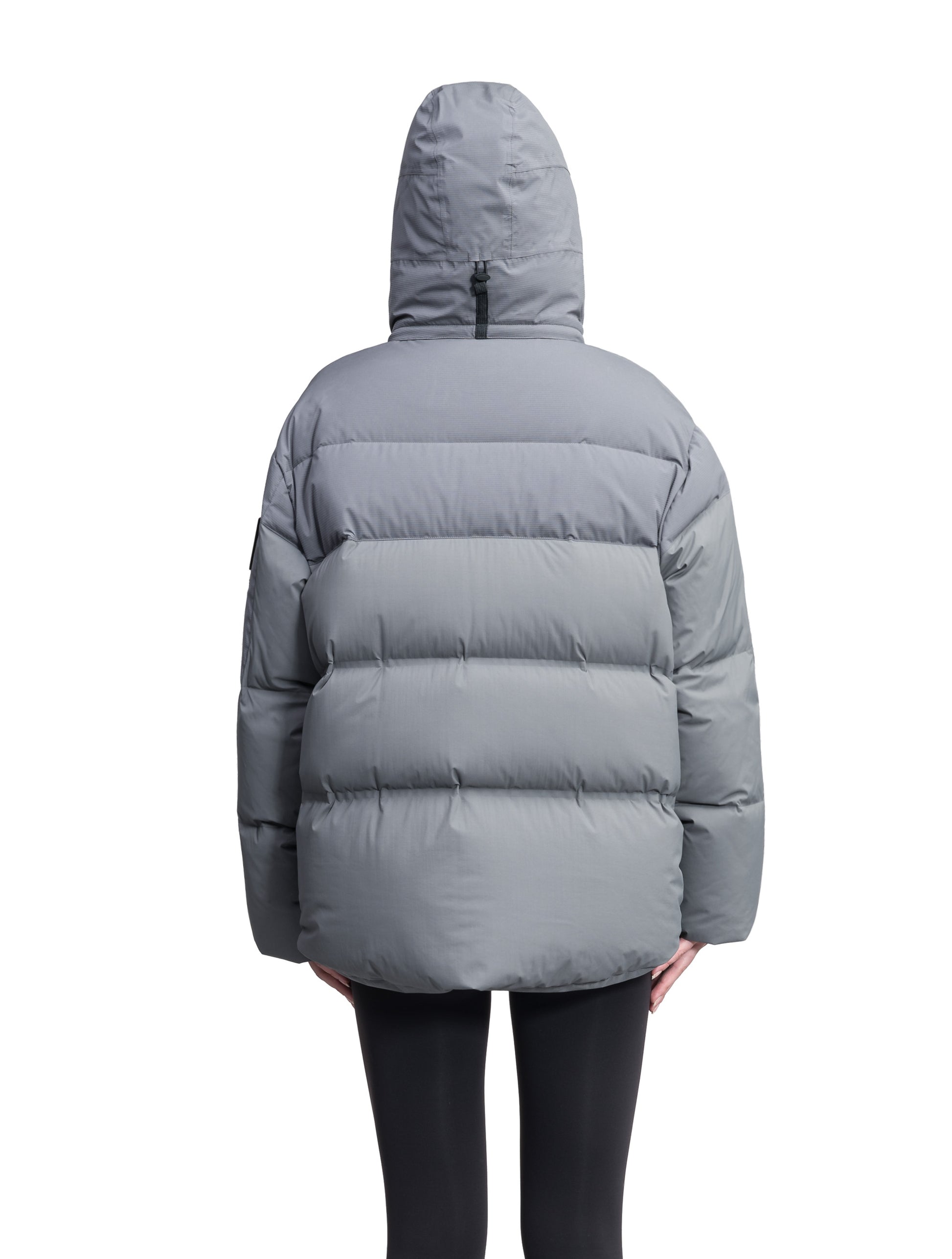 Una Ladies Performance Puffer in hip length, Technical Taffeta and Durable Stretch Ripstop fabrication, Premium Canadian White Duck Down insulation, removable down filled hood, centre front two-way zipper, and side-entry pockets at waist, in Concrete