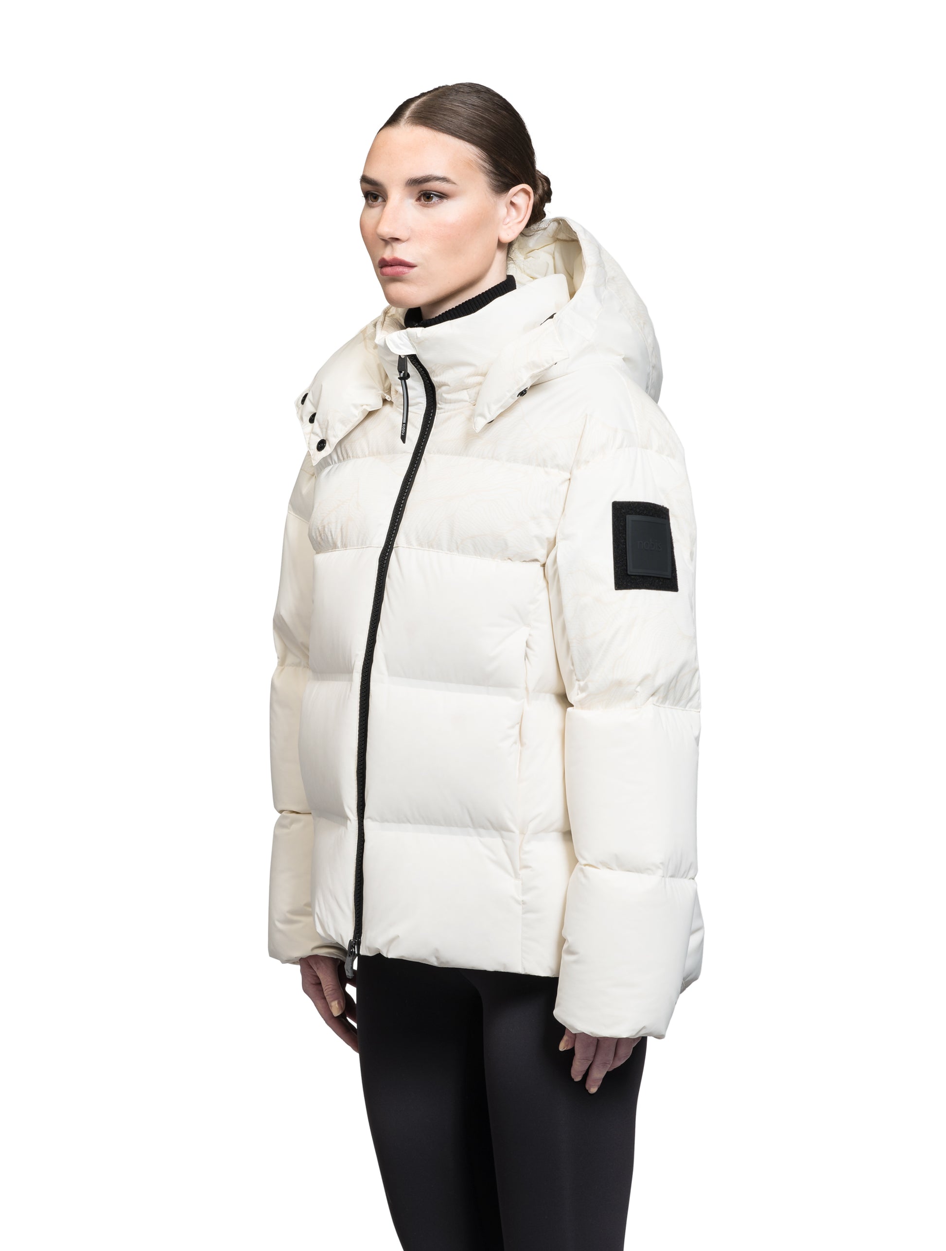 Una Ladies Performance Puffer in hip length, Technical Taffeta and Durable Stretch Ripstop fabrication, Premium Canadian White Duck Down insulation, removable down filled hood, centre front two-way zipper, and side-entry pockets at waist, in Wheat Desert