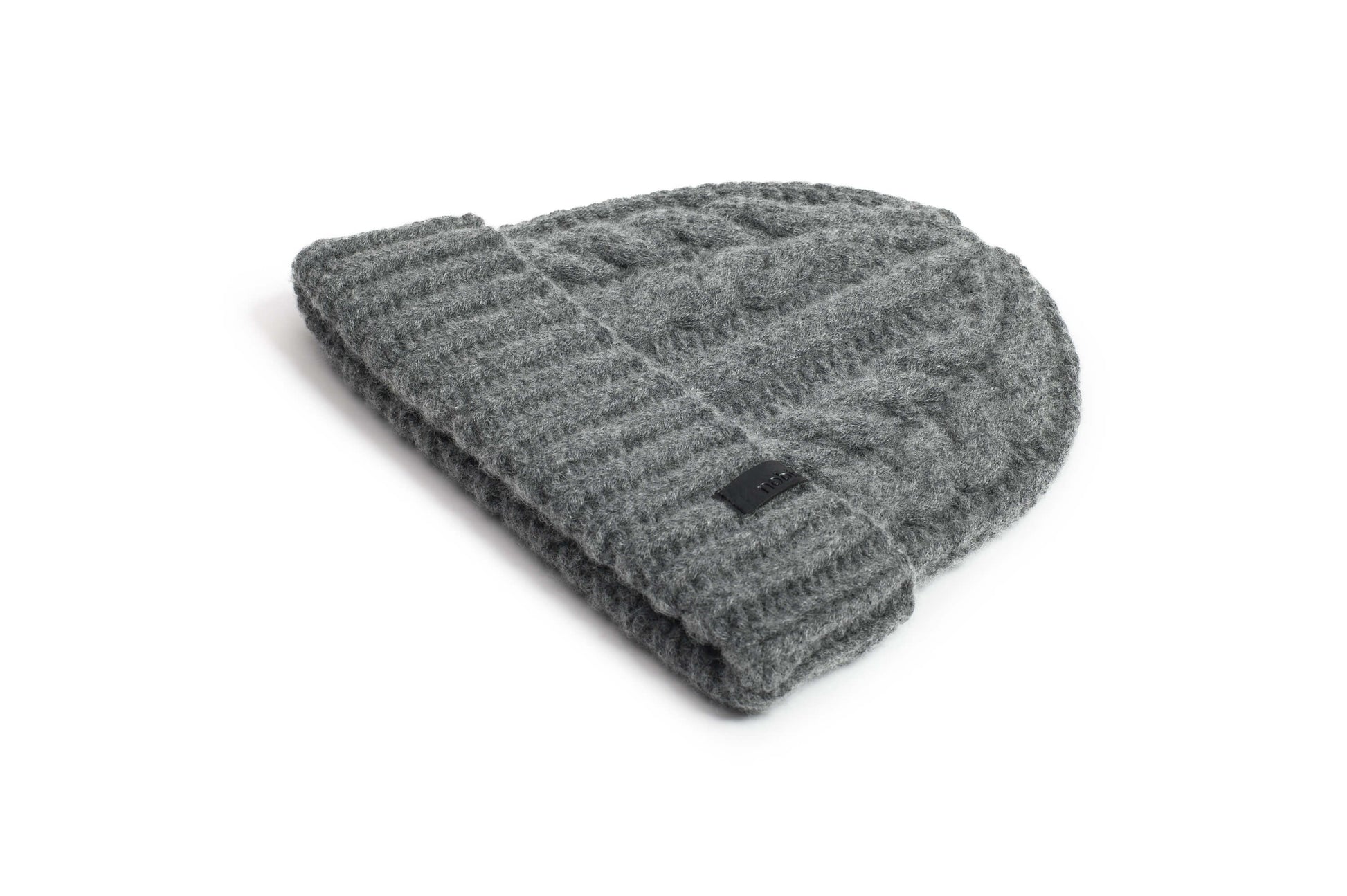 Dew Unisex Cable Knit Beanie in superfine merino wool and cashmere, and nobis leather label at cuff, in Storm